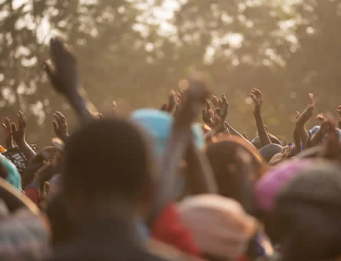 Crowd of people hold up hands in african village seeking emergency water rations. Aqua COntrol group of companies have extensive experience working in Nigeria, Kenya, Ethiopia and Gulf States.